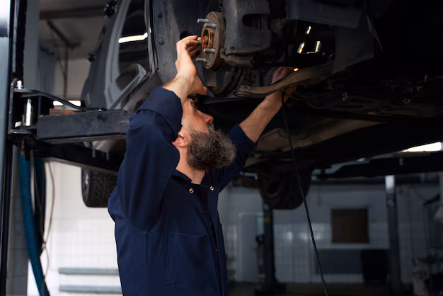 male-mechanic-working-car